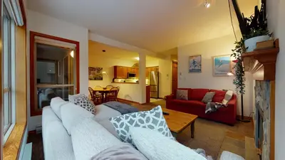 a living room with a couch and a table at 2BR in Painted Cliff, Ski In, Ski Out, Communal Hot Tub, Wood Burning Fireplace, Free Parking in Whistler