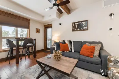 a living room with a couch and a table at Heavenly Mountain Hideaway, Pool, Hot Tub in Radium Hot Springs