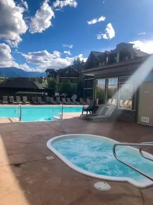 a swimming pool with a jacuzzi tub in a house at Chic Retreat, Modern, Pool, Hot Tub, Gym in Invermere
