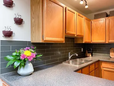 a kitchen with a vase of flowers on a counter at Radium Villas in Radium Hot Springs