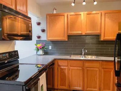a kitchen with wooden cabinets and a sink at Radium Villas in Radium Hot Springs
