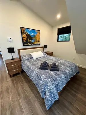 a bedroom with a bed with two towels on it at Revelstoke Modern Farmhouse in Revelstoke