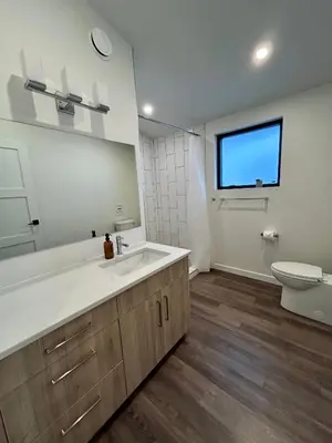 a bathroom with a large sink and a toilet at Revelstoke Modern Farmhouse in Revelstoke