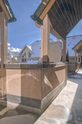 a view of a building from a parking lot at Incredible Mountain View Townhouse in DT Canmore w/ A/C & U/A Parking in Canmore