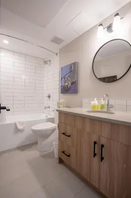 a bathroom with a sink toilet and a mirror at Basecamp Suites Banff in Banff