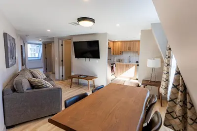 a living room with a table and a couch at Basecamp Suites Banff in Banff