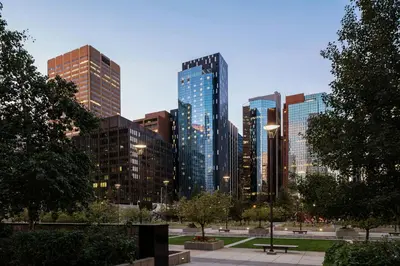 a city skyline with tall buildings in a park at The Dorian, Autograph Collection in Calgary