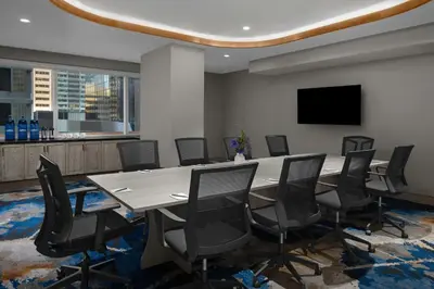 a conference room with a large table and chairs at The Dorian, Autograph Collection in Calgary