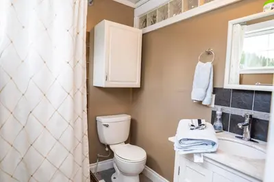 a bathroom with a toilet and a sink at Downtown Whitehorse Apartment in Old Town in Whitehorse