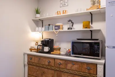 a microwave sitting on top of a wooden cabinet at Harrison On The Lake, Walkable to Beach and Village in Harrison Hot Springs