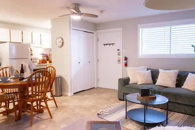 a living room with a couch and a table at Harrison On The Lake, Walkable to Beach and Village in Harrison Hot Springs