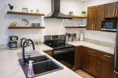 a kitchen with a sink and a stove top oven at Storm Bay, Family Home with Hot Tub and Inlet View in Ucluelet