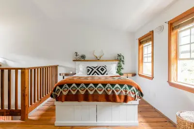 a bedroom with a bed in a room at Fern Gully, Coastal Bohemian Loft at Beach in Ucluelet