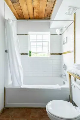 a bathroom with a white tub and a toilet at Fern Gully, Coastal Bohemian Loft at Beach in Ucluelet