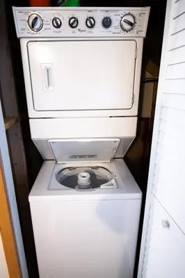 a washer and dryer in a small room at Kingfisher, Waterfront Cabin with Inlet with Mountain Views in Ucluelet