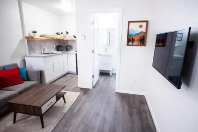a small living room with a couch and a table at Kingfisher, Newly Renovated Suite on Ocean Inlet in Ucluelet