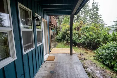 an open door of a house with a porch at Kingfisher, Newly Renovated Suite on Ocean Inlet in Ucluelet
