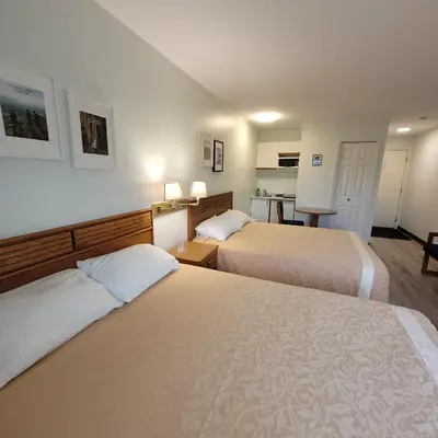 a hotel room with two beds and a kitchen at Ridgeview Motor Inn in Gold River