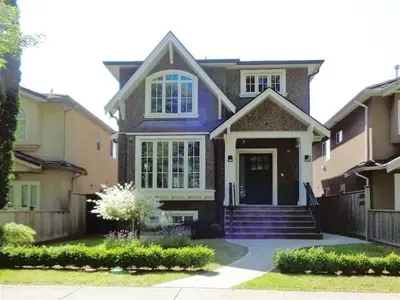 a house with a blue front door and stairs at Cozy Guest Suite in Quiet Home with Private Entry in Vancouver