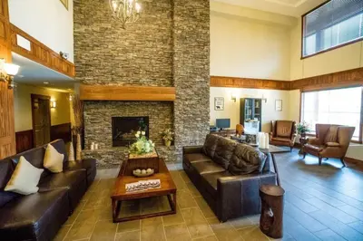 a living room with a couch and a fireplace at Spacious Penthouse Suite-King Beds-Pool & Hot Tub in Canmore