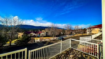 a balcony with a white fence and a parking lot at Mountain View Suites by StayIn in Fairmont Hot Springs
