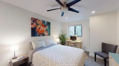 a bedroom with a bed and a ceiling fan at Greyhawk by Whistler Premier in Whistler
