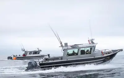 two fishing boats are in the water at The Hiker Huts in Port Renfrew