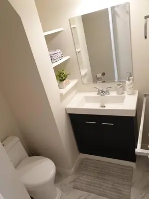 a bathroom with a sink and a toilet and a mirror at Happy, Cozy, Loving Guest Space in West Vancouver in West Vancouver