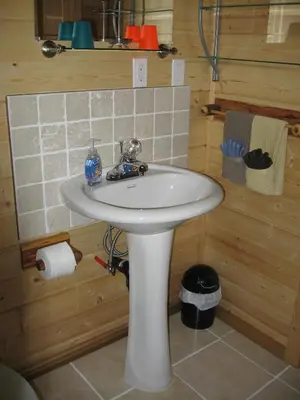 a bathroom with a white sink in a cabin at Tschurtschenthaler Rentals in Golden