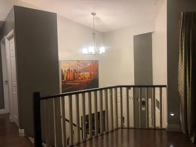a room with a staircase with a painting on the wall at citadel hills valley in Calgary