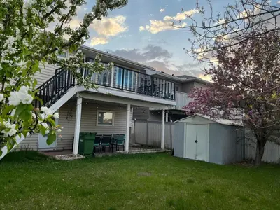 a house with a balcony and a yard at citadel hills valley in Calgary