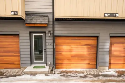 two garage doors on the side of a building at Casa de Luna by Canadian Rockies Vacation Rentals in Canmore