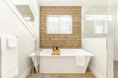 a bathroom with a white sink and a window at The White Pearl - Amazing Luxury Chalet with Mountain Views in Big White