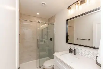 a bathroom with a shower and a toilet and a sink at The White Pearl - Amazing Luxury Chalet with Mountain Views in Big White