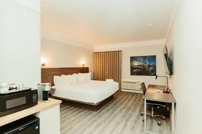 a hotel room with a bed and a tv at Northwinds Hotel Canmore in Canmore