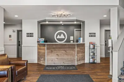a lobby with a bar with a sign on the wall at Northwinds Hotel Canmore in Canmore