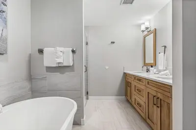 a white bathroom with a tub and a shower at BRAND NEW - Gorgeous Spring Creek Penthouse in Canmore