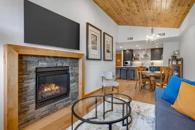 a living room with a fireplace and a tv at Spring Creek Vacations in Canmore