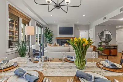 a living room with a dining table and a couch at Spring Creek Vacations in Canmore