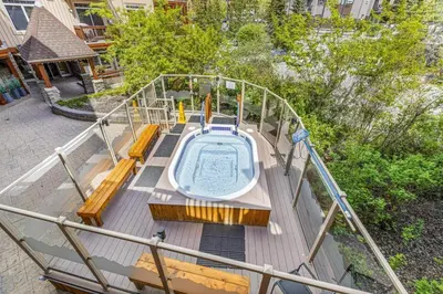 a deck of a boat with a hot tub on it at Sunny Tranquil Woods Turret in Falcon Crest Lodge in Canmore