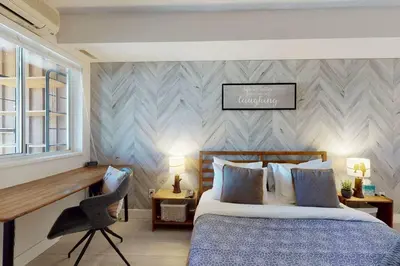 a bedroom with a bed and a desk and a chair at 1BR plus Den in Marketplace Lodge, Village Location, Mountain Views, Complex Hot Tub in Whistler