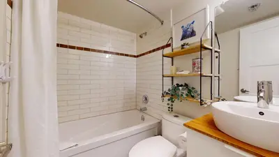 a bathroom with a tub and a sink and a toilet at 1BR plus Den in Marketplace Lodge, Village Location, Mountain Views, Complex Hot Tub in Whistler