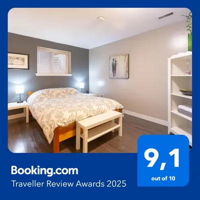 a bedroom with a bed and a book shelf at Suite Sunrise in Vancouver