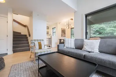 a living room with a couch and a table at Powderview 24 by Outpost Whistler in Whistler