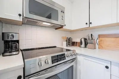 a kitchen with a stove and a microwave at Powderview 24 by Outpost Whistler in Whistler