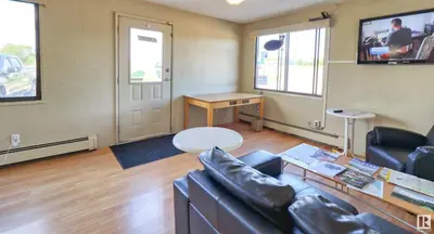 a living room with a couch and a table at Kings Court Motel in Cold Lake