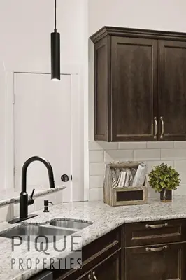 a kitchen with a sink and a counter top at Mountain Haven Retreat, Pool & Hot Tub, UG Parking, Fitness Centre, WiFi! in Canmore