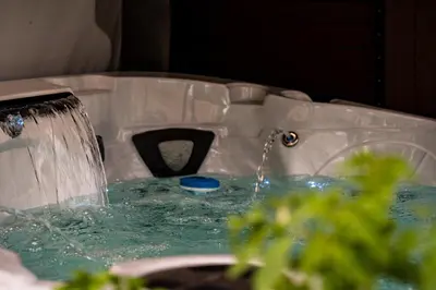 a tub filled with water with a fountain at Modern yet comfy 3 bed suite in Surrey in Surrey