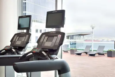 three automated exercise machines in front of a building at Auberge Vancouver Hotel in Vancouver