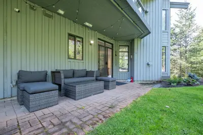 a patio with couches and chairs on a house at Ravencrest by Outpost Whistler in Whistler
